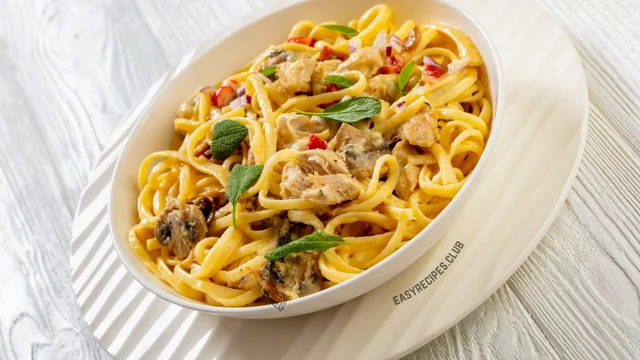 pasta with chicken and vegetables in a white bowl on a wooden table easy dinner ideas