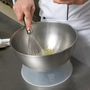 A large mixing bowl is used to combine ingredients before cooking, such as mixing .