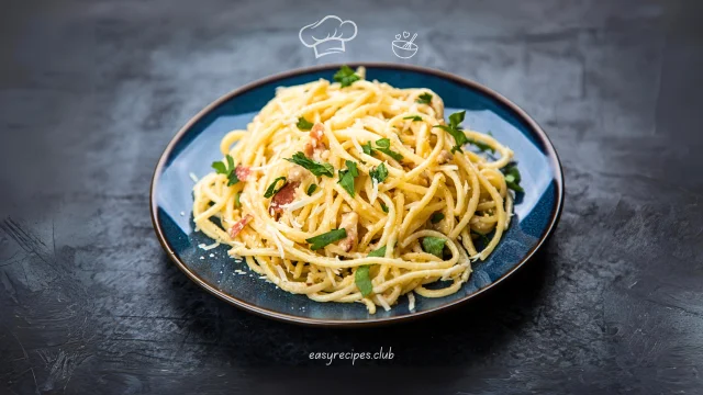 A plate of Quick and Easy Spaghetti Carbonara with crispy bacon and a sprig of parsley on a marble countertop in a modern kitchen.