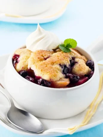 presentation of Chez Panisse Blueberry Cobbler recipe with topping creamy