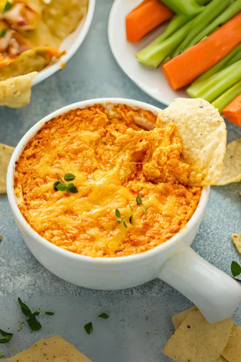 A creamy and cheesy Buffalo chicken dip  recipe served with fresh vegetables and chips.