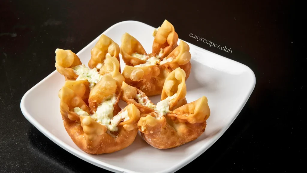 Crab Rangoon  recipe neatly arranged in a circular pattern on a round serving platter.