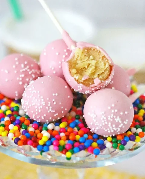 Close-up of perfectly round Starbucks Birthday Cake Pops with pink coating, ready to be enjoyed.