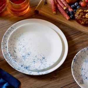 A set of white ceramic plates and serving dishes in various sizes.